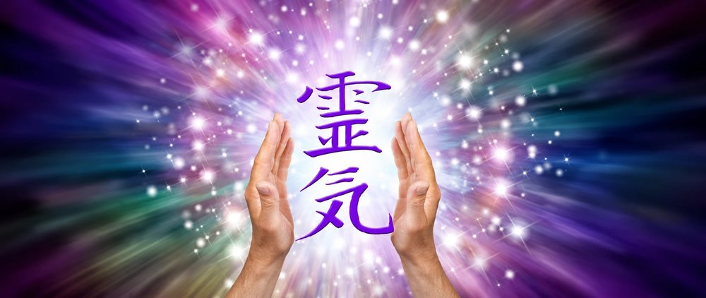 Open hands held either side of the Japanese characters for Reiki, 霊気.